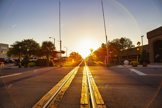 Picture of Train Tracks Through Town Sunset